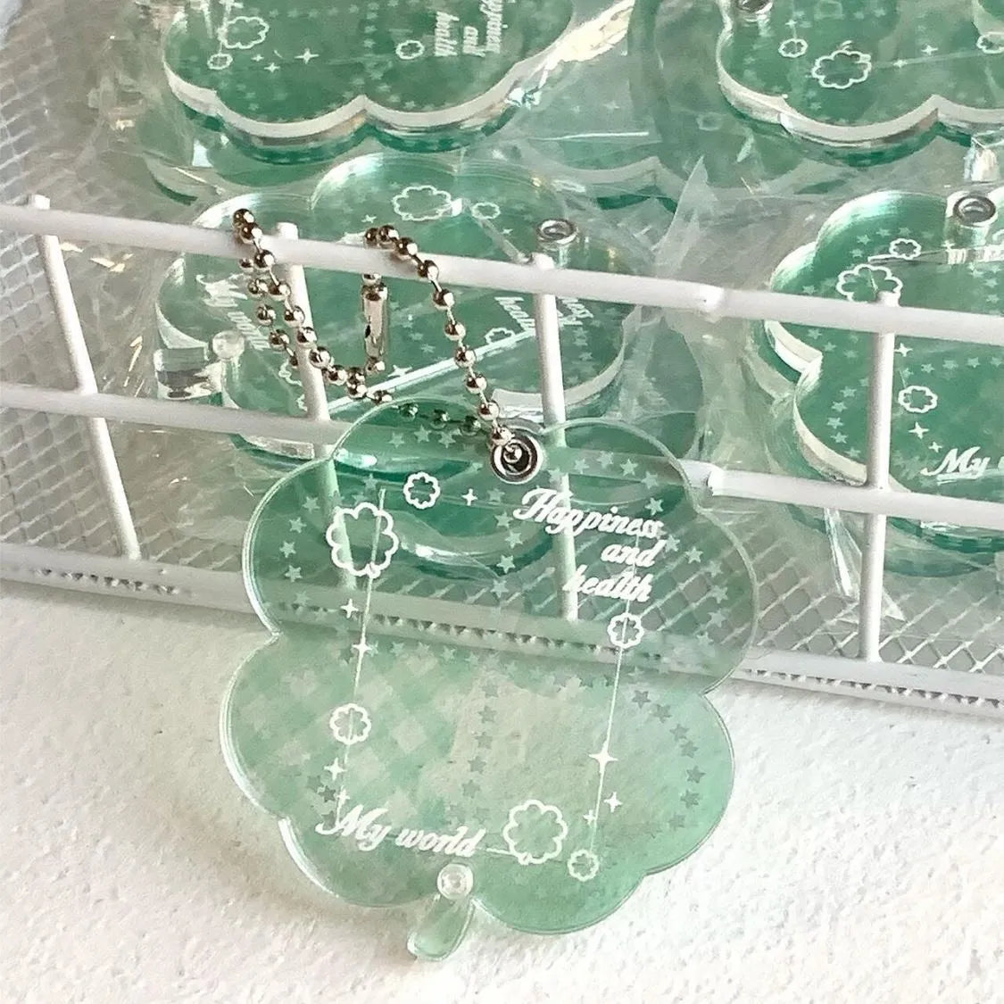 Acrylic four-leaf clover keychain pendant in blue, green, or mint colour options.