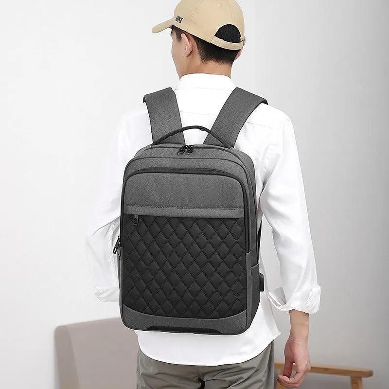 Men's Oxford cloth leisure travel backpack in black with curved shoulder strap and diamond mesh detail