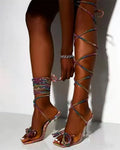Plus size women's black strappy sandals with Roman rhinestone strap detail and square toe.