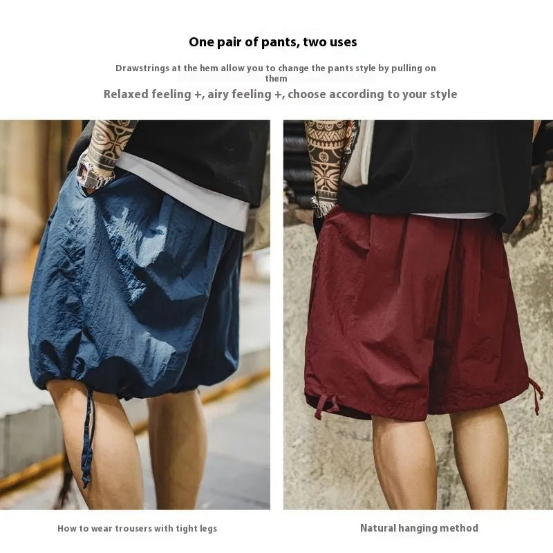 Men's loose fit Prussian blue nylon beach shorts with embroidery on a white background.