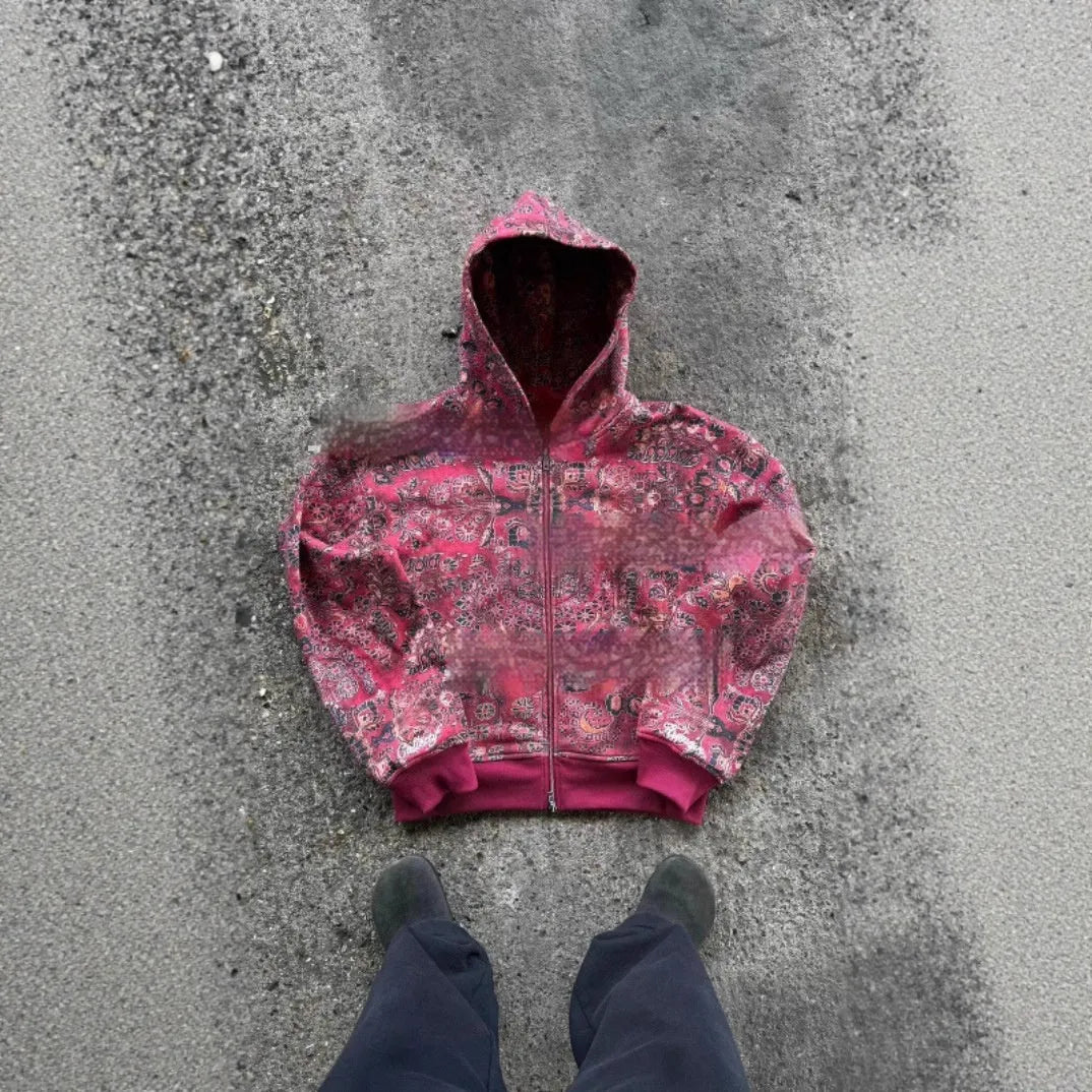 A man's loose-fitting blue hooded zip coat with long sleeves on a hanger.