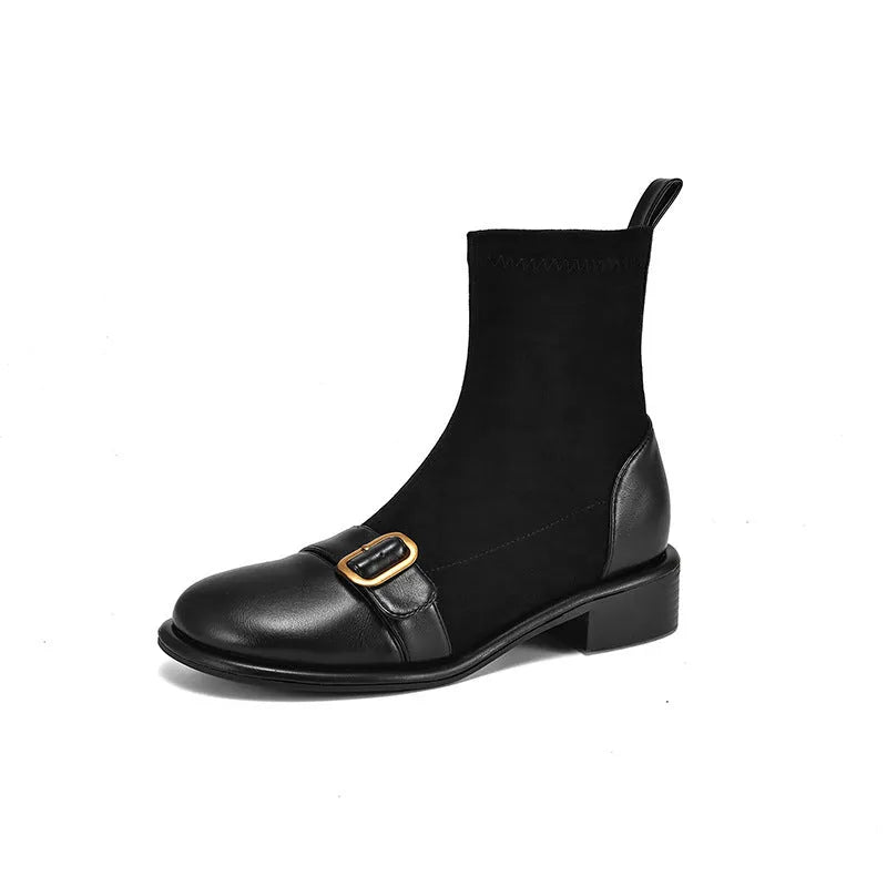 Women's black low heel lace-up Martin ankle boots with belt buckle detail on a white background.