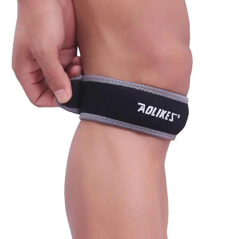 Black and grey patellar retinaculum knee support for running and sports.
