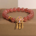 Women's bracelet with strawberry quartz dream catcher pendant on wrist