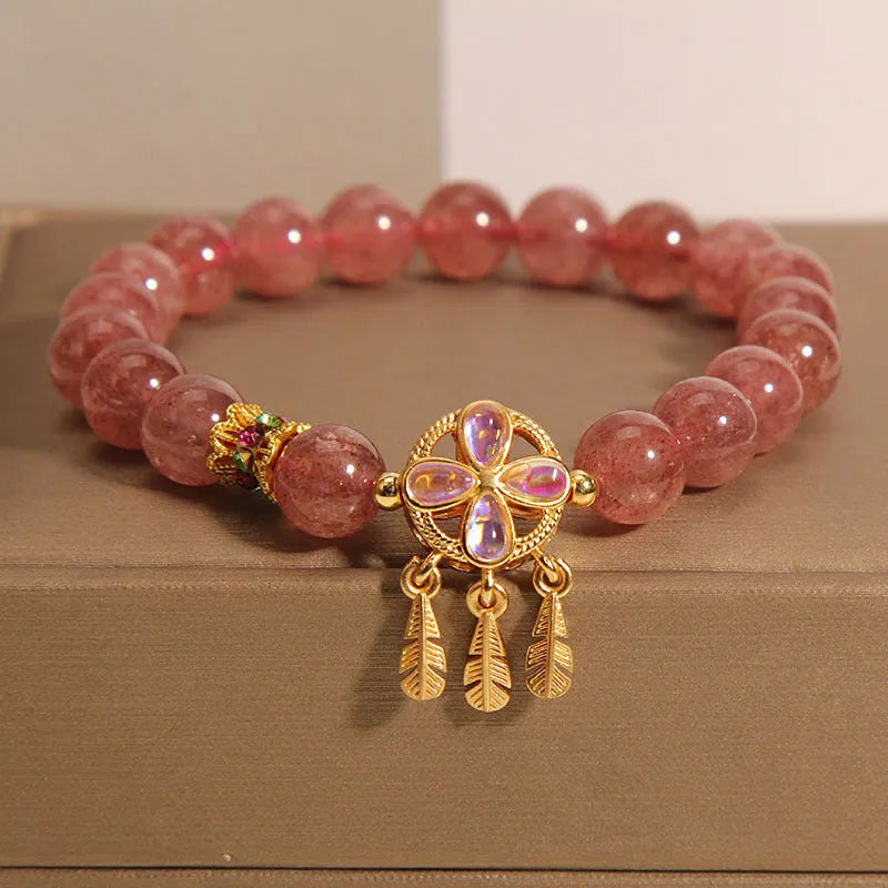 Women's bracelet with strawberry quartz dream catcher pendant on wrist
