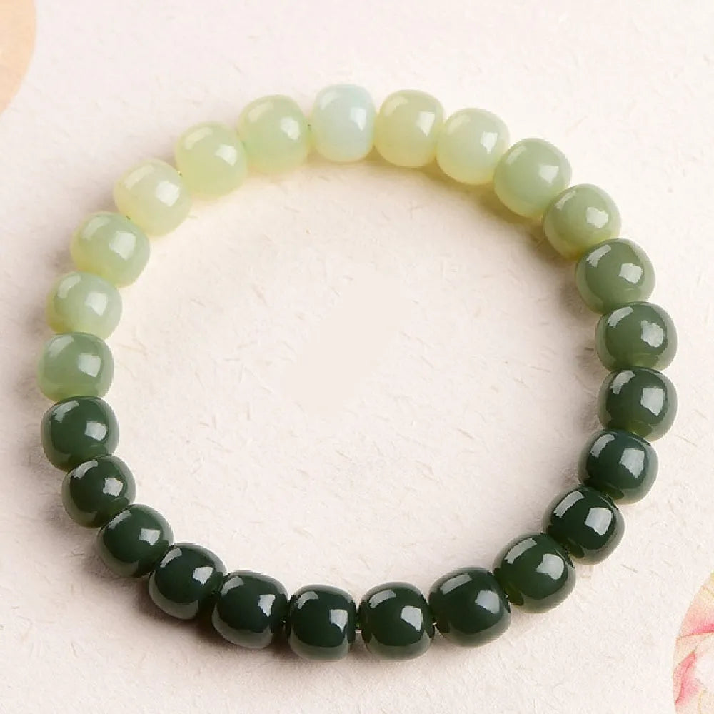 Hetian jade bracelet with clear water gradient beads on wrist.