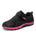 Women's grey purple low-top casual shoes with Velcro strap and wedge heel on a plain background.