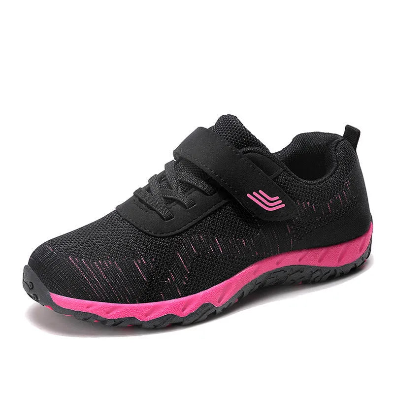 Women's grey purple low-top casual shoes with Velcro strap and wedge heel on a plain background.