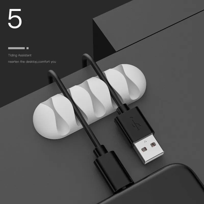 Smart cable holder with TPR flexible clips in black holding USB earphone and network cables on a desk