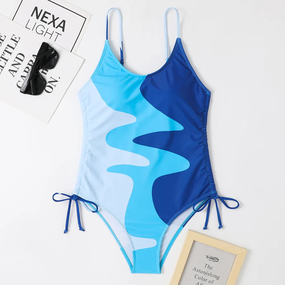 Women's blue sleeveless one-piece swimsuit with fixed trunks on a mannequin.