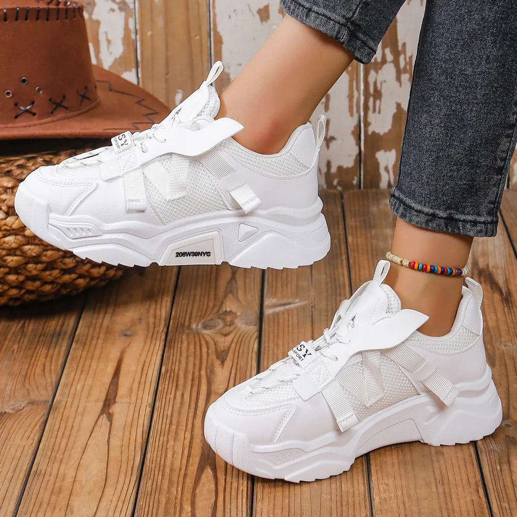 Women's platform mesh dad sports trainer in animal pattern, showing lace-up front and height-increasing sole.
