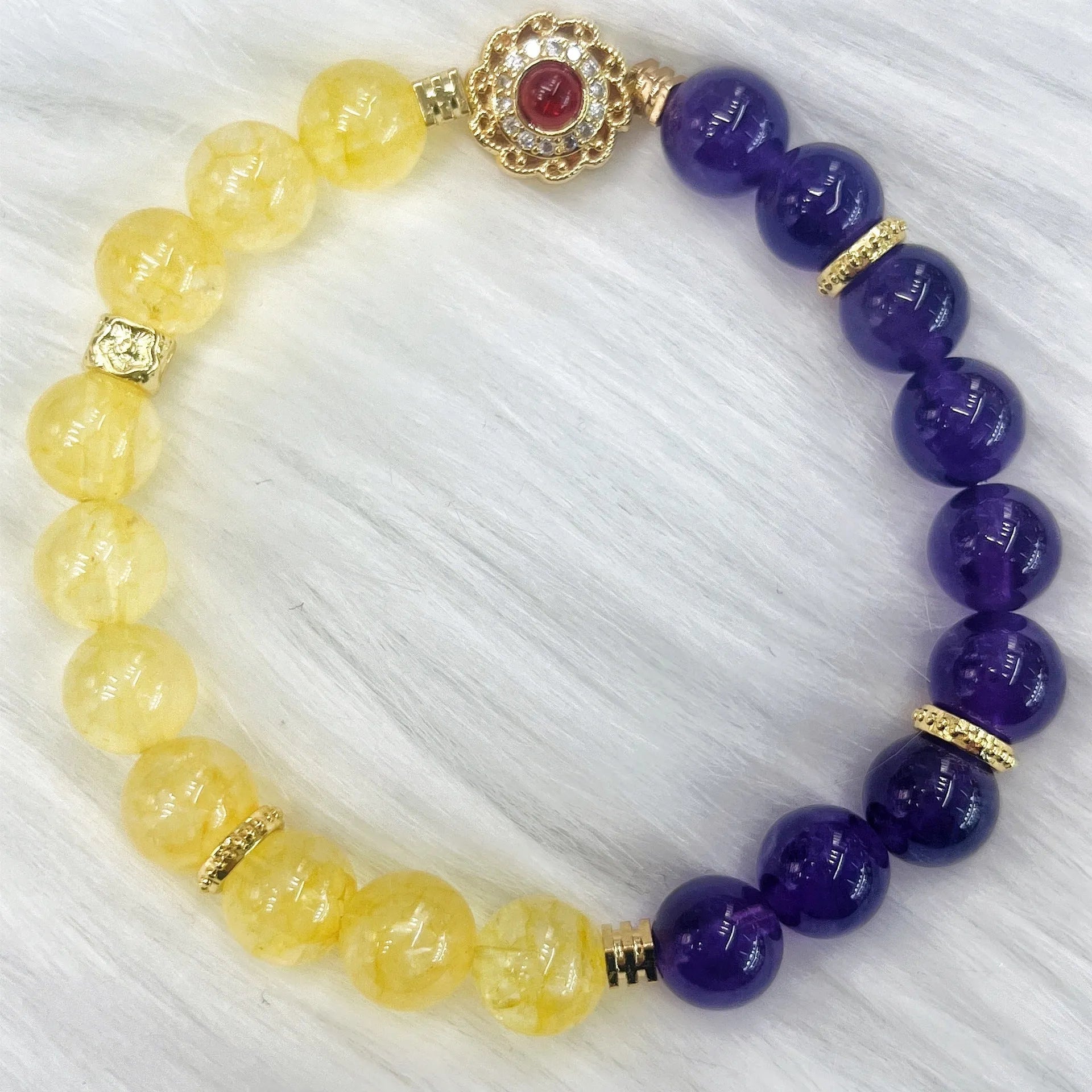 Handmade women's yellow and purple amethyst crystal bracelet on wrist