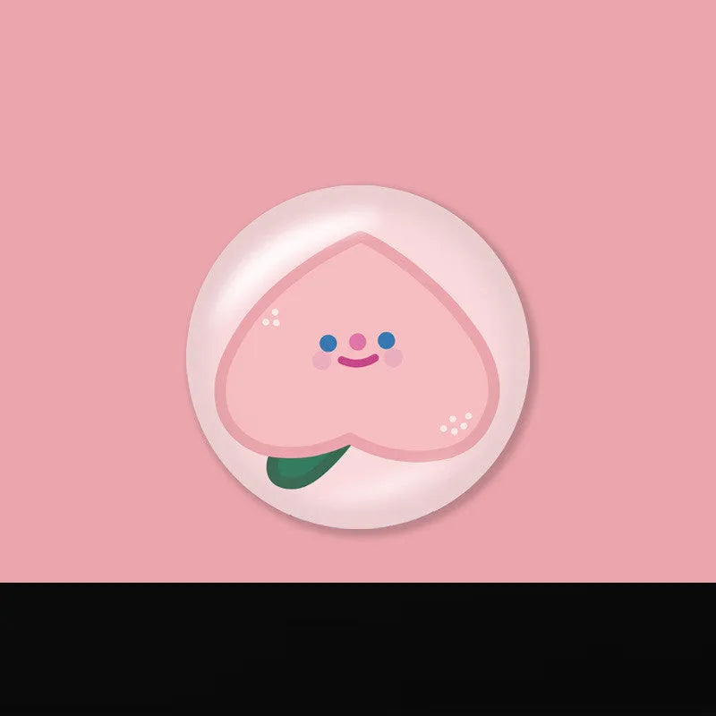 Creative telescopic glue cartoon phone airbag bracket in colour C1 girl design on a desk holding a smartphone