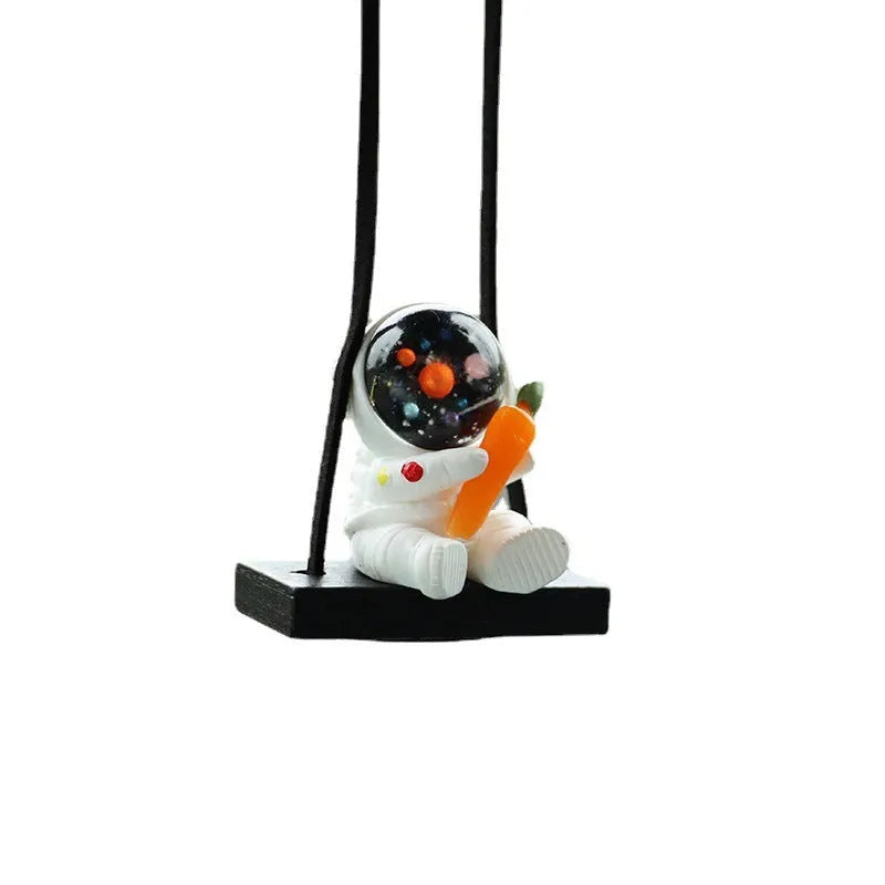 Resin cartoon astronaut car pendant decoration hanging from a rear-view mirror.