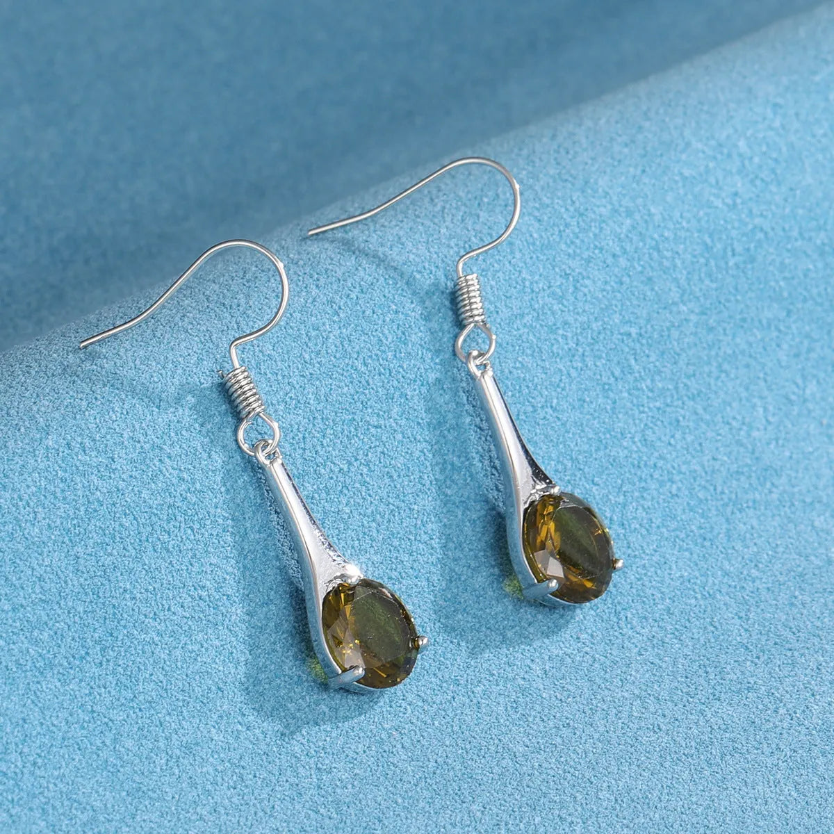 Olive green water drop shaped retro earrings with minimalist design on alloy base