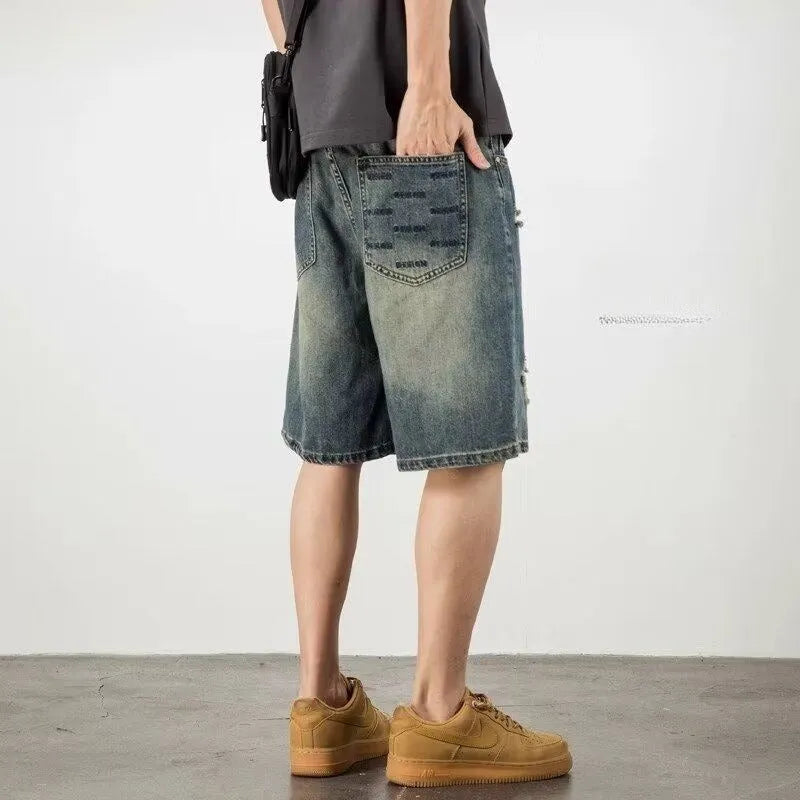 Blue retro loose hole men's denim shorts on a neutral background