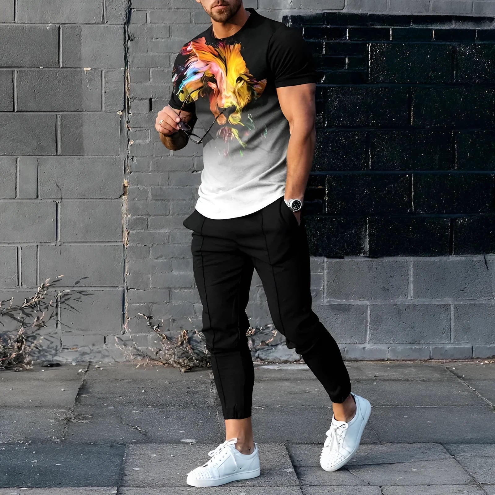 Man wearing a printed short-sleeve pullover and matching trousers from a thin polyester sports suit set.