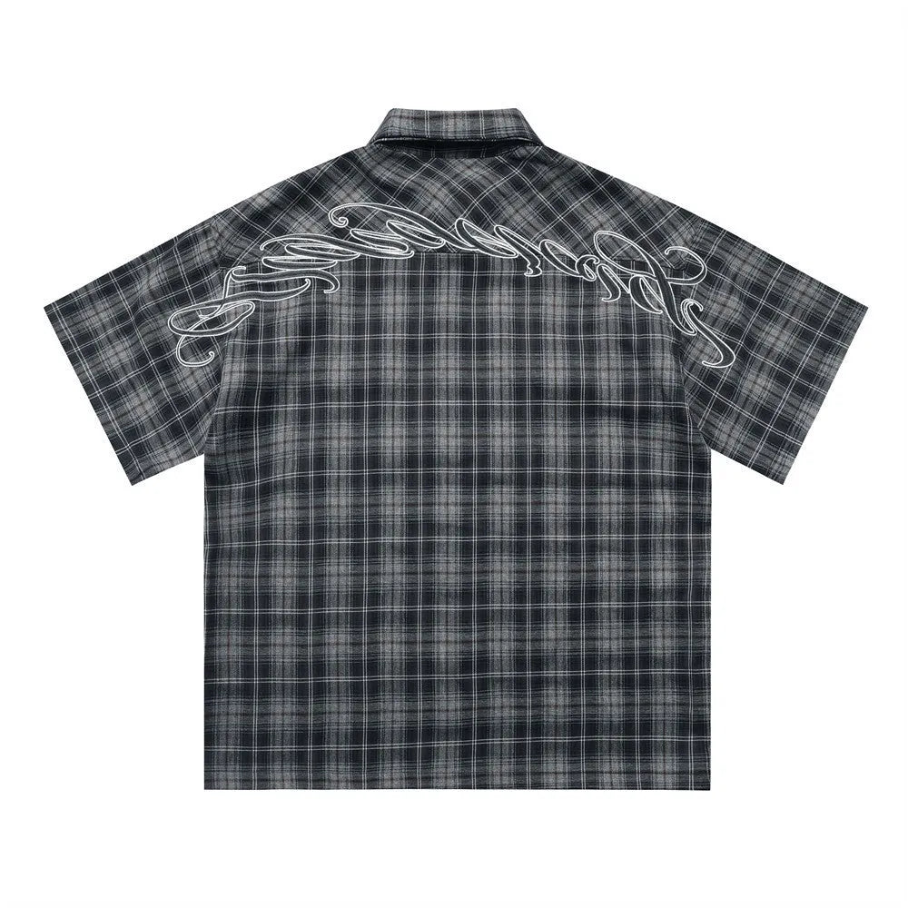 Men's black and brown plaid short sleeve shirt with embroidered letter and lapel collar.