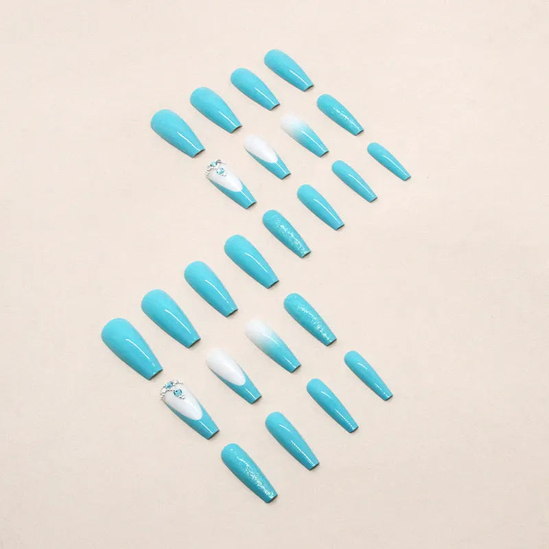 Solid colour long ballet false nails with blue diamond glitter accents and adhesive glue