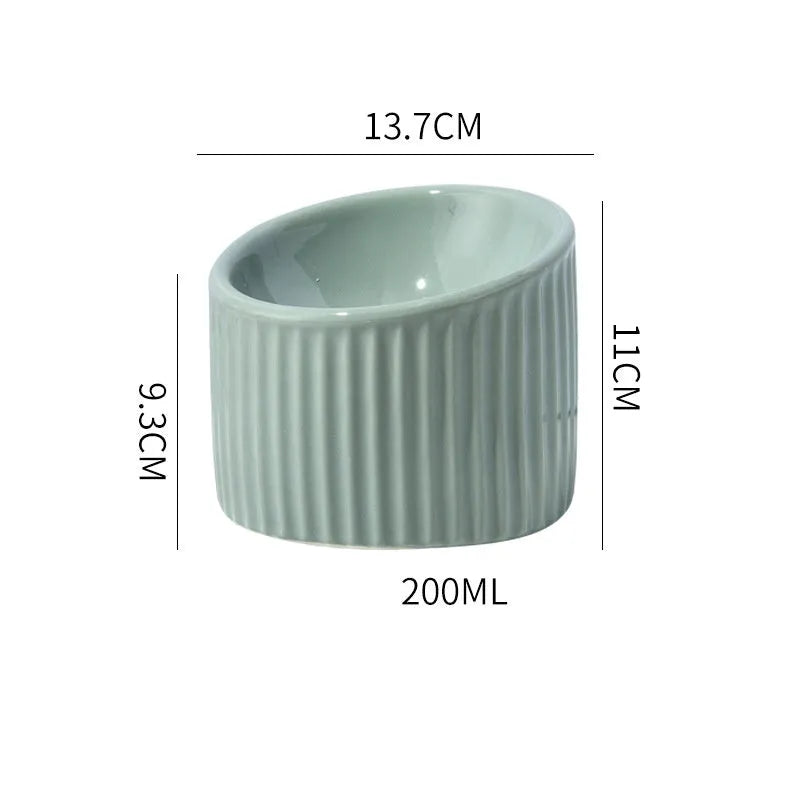 Ceramic elevated cat bowl in round tilted design with raised height for indoor cats