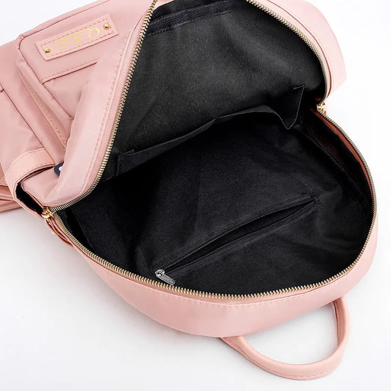 Women's casual backpack in black or pink with 20L capacity, waterproof nylon construction, and internal organiser compartments