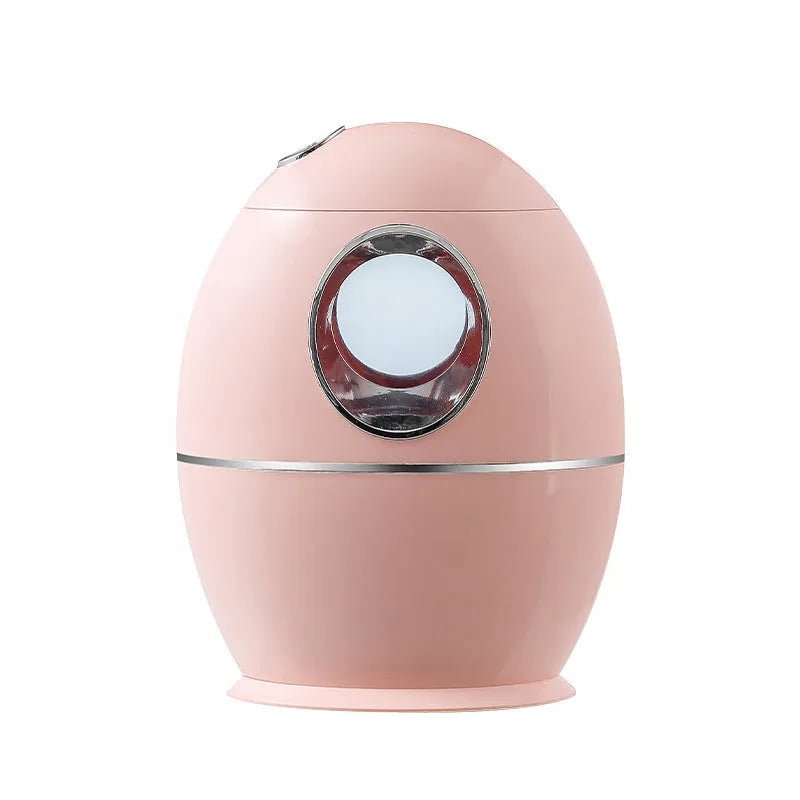 White round aromatherapy humidifier with USB cable and water tank showing mist output