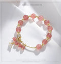 Women's pink crystal bracelet with heart-shaped design and pearl accents in strawberry quartz colour