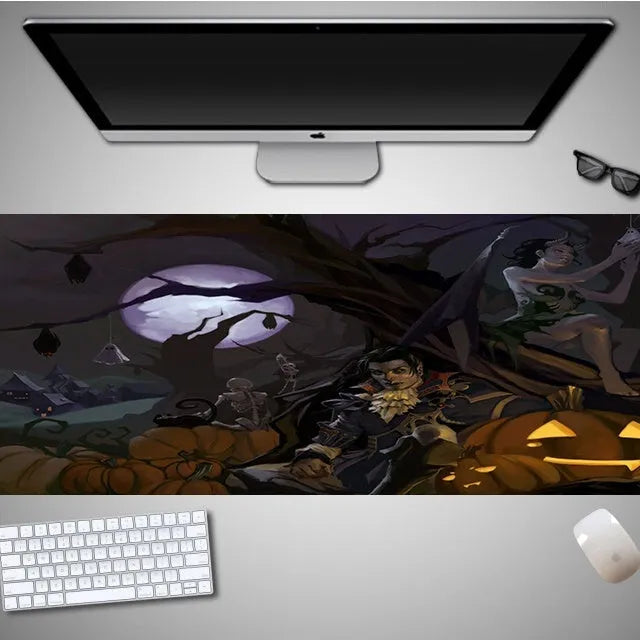 Oversized Halloween graphic cloth mouse pad on a desk, showing non-slip rubber base.