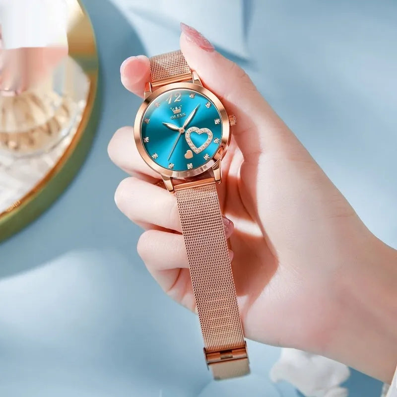 Women's rose shell case fashion watch with mesh strap, showing multiple dial colour options.