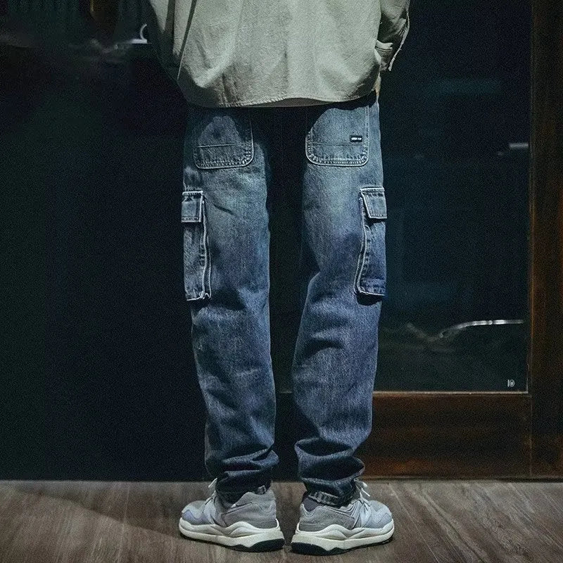 Men's blue loose straight-leg stretch denim trousers with elastic waistband and zip fly placket