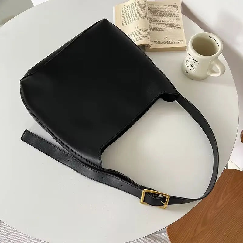Women's soft PU shoulder bag with swing threads in black or brown colour options