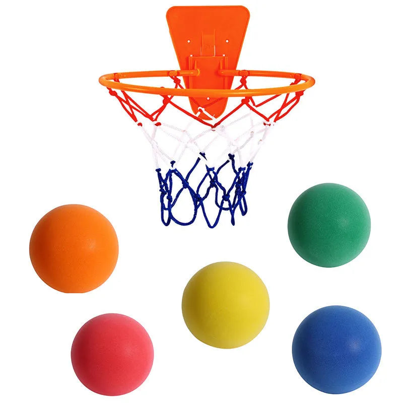 Assortment of bright coloured silent foam basketballs with a basketball frame on a neutral background