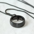 Men's silver pearl chain circle pendant necklace with stainless steel chain and titanium steel pendant on neutral background