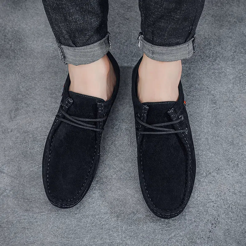 Men's black slip-on loafers with synthetic PU upper, stitched detailing, and non-slip plastic sole