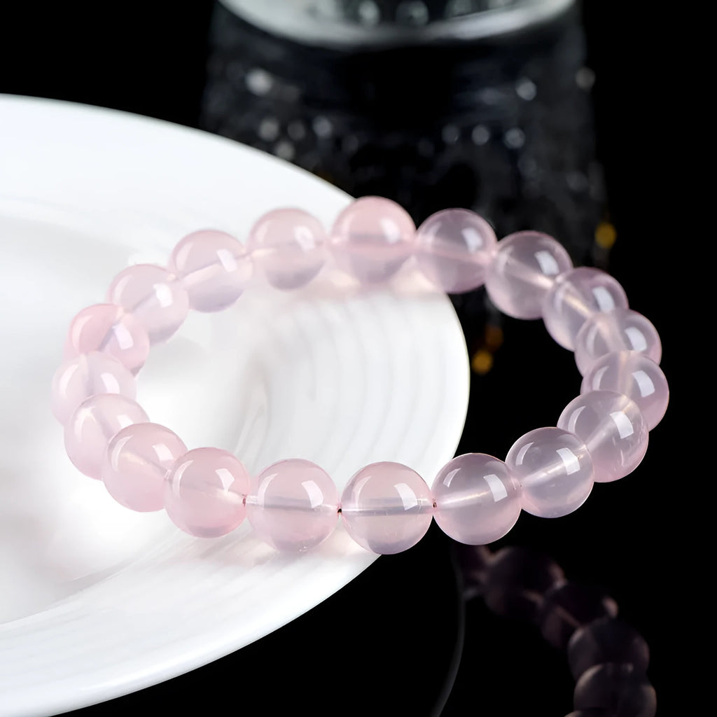 Women's natural starlight crystal round bead bracelet in pink, showing polished finish and single circle bead arrangement.