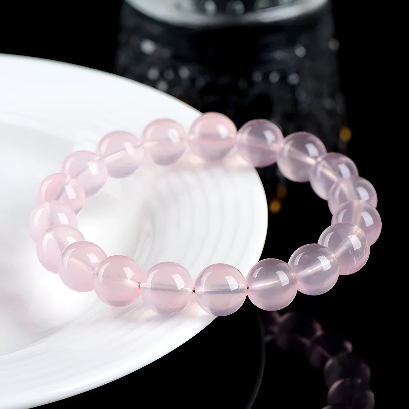 Women's natural starlight crystal round bead bracelet in pink, showing polished finish and single circle bead arrangement.