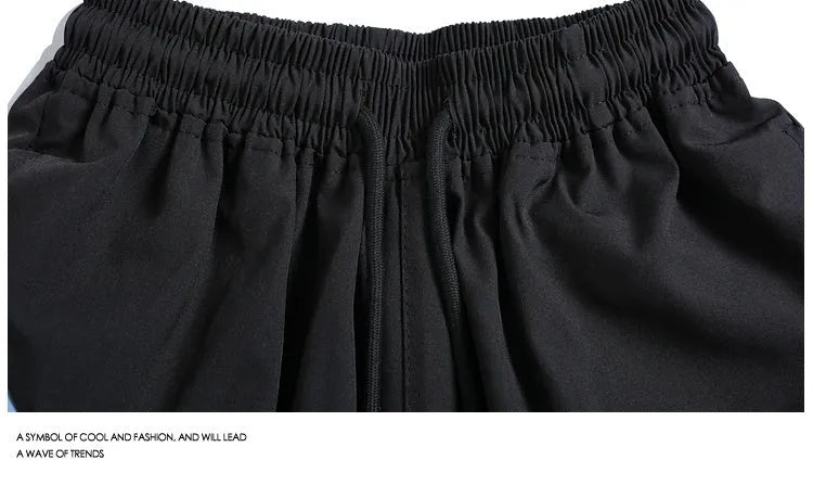 Quick-drying black sports shorts with elastic waistband and straight-leg loose fit for training