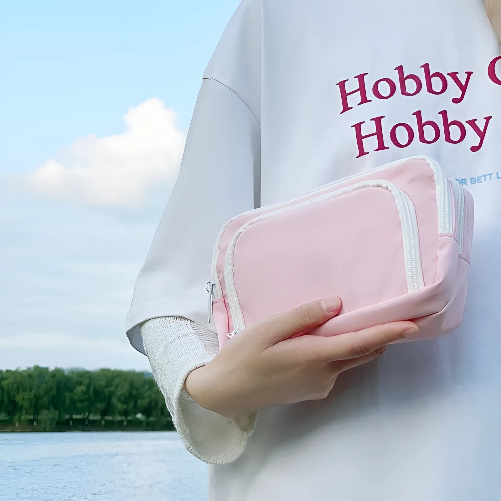 Double-layer pencil case in blue showing internal compartments and a top carry handle
