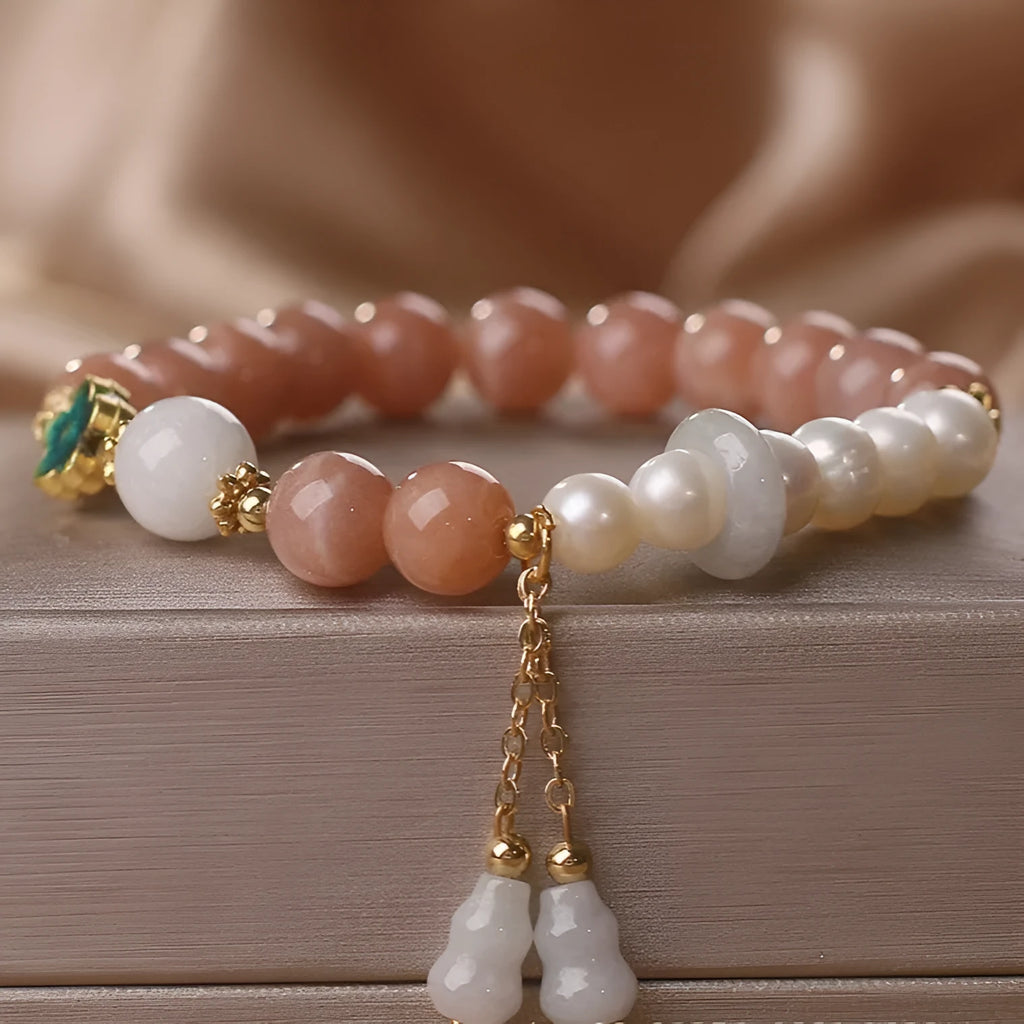 Natural sunstone bracelet with orange sunstone jade calabash pendant and moonstone beads on display