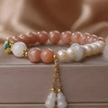 Natural sunstone bracelet with orange sunstone jade calabash pendant and moonstone beads on display