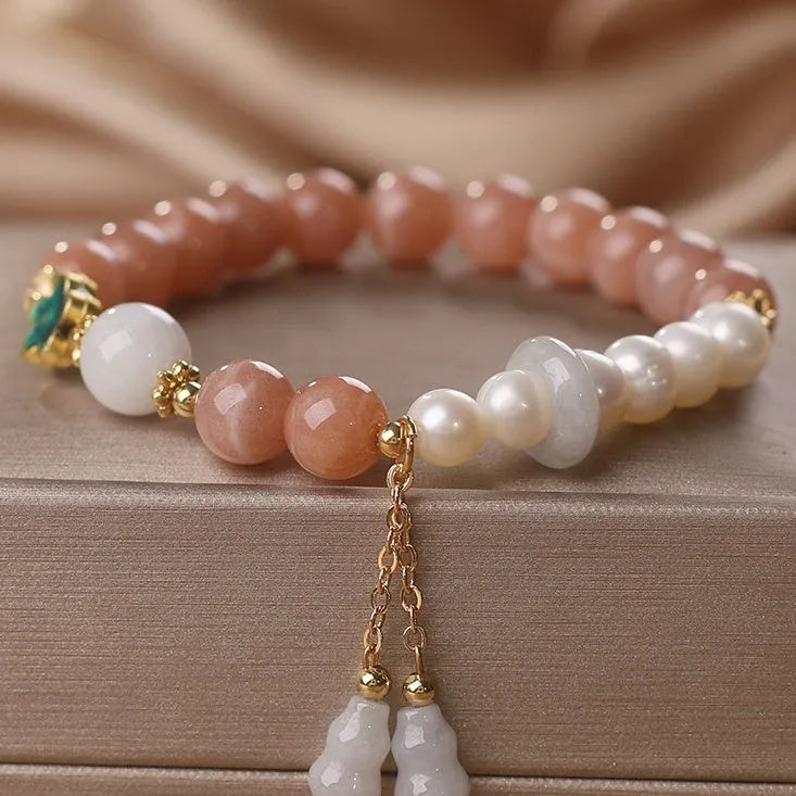 Natural sunstone bracelet with orange sunstone jade calabash pendant and moonstone beads on display