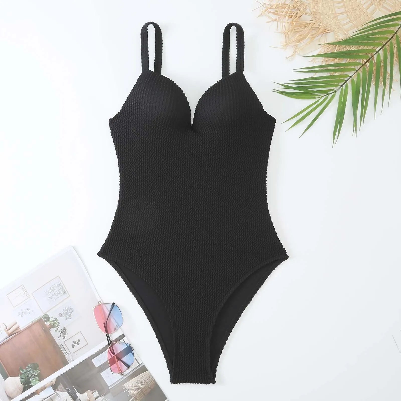 Women's black sunk stripe one-piece swimsuit made from polyester, shown on a mannequin.