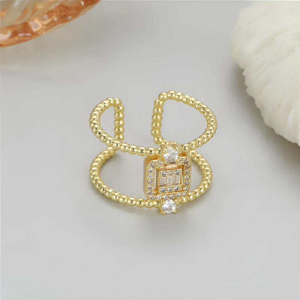 Adjustable open mouth copper ring with asymmetric U-shape and gold plating.