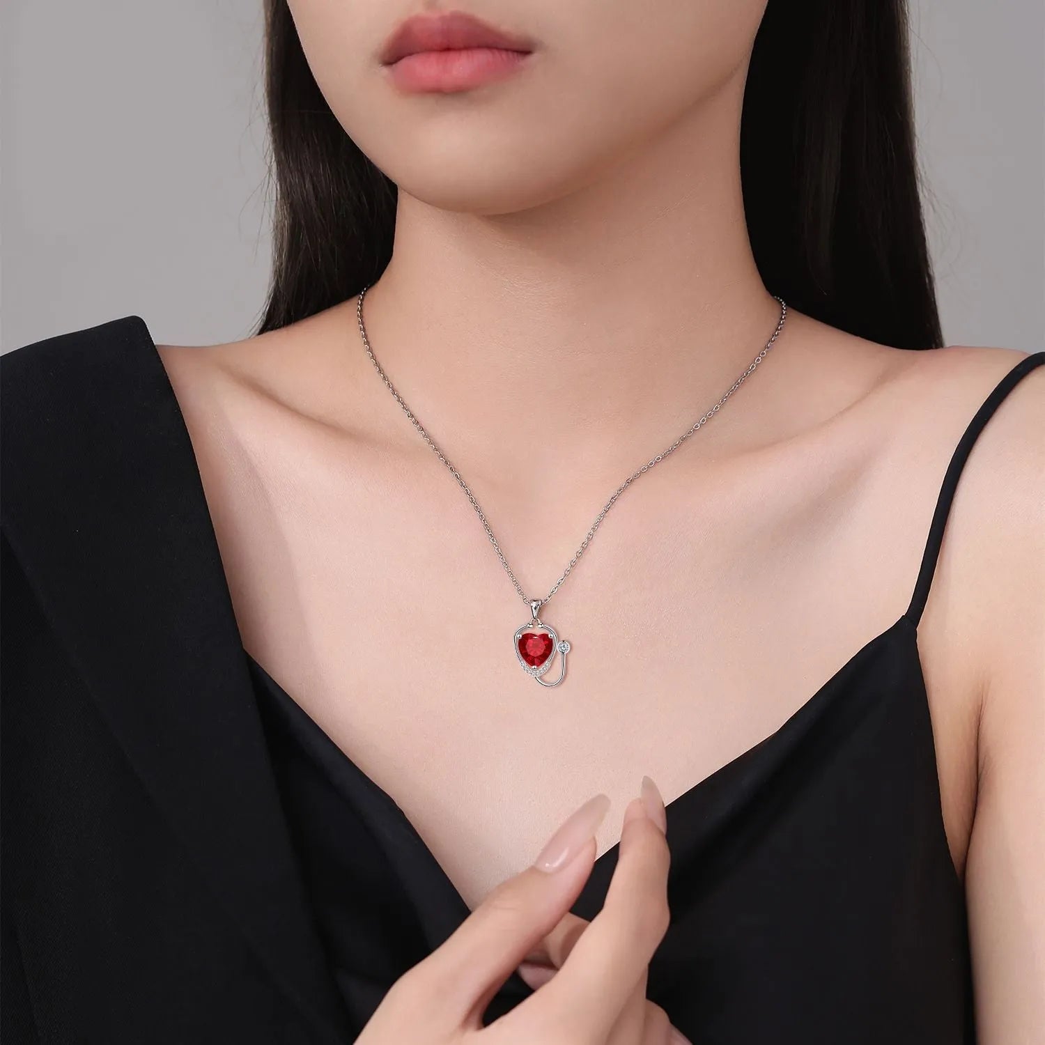 Women's copper stethoscope necklace with red diamond colour pendant on model