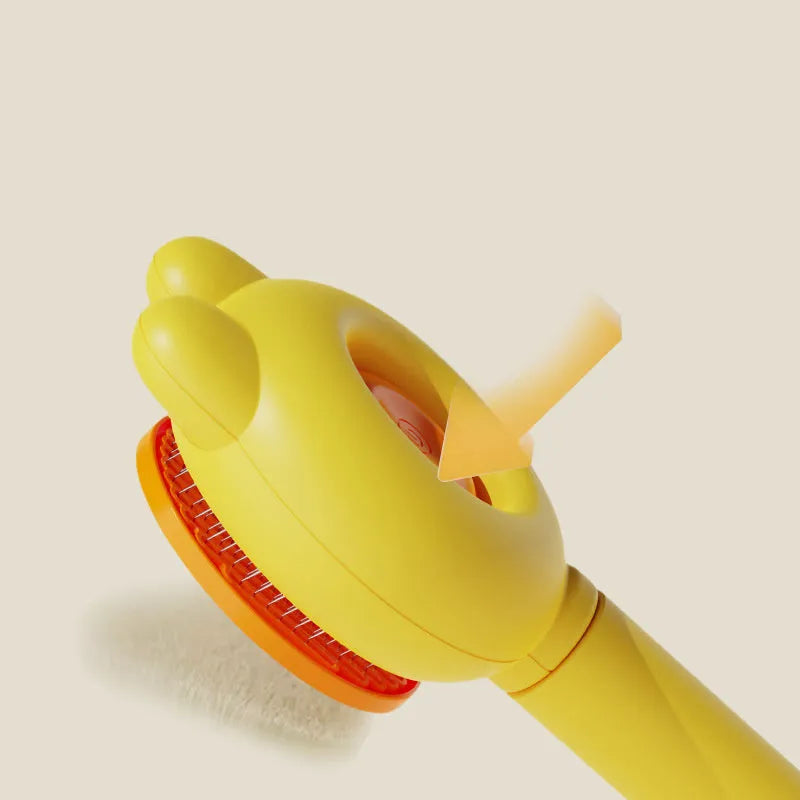 Self-cleaning pet grooming brush with green handle and stainless steel comb, showing the release button.