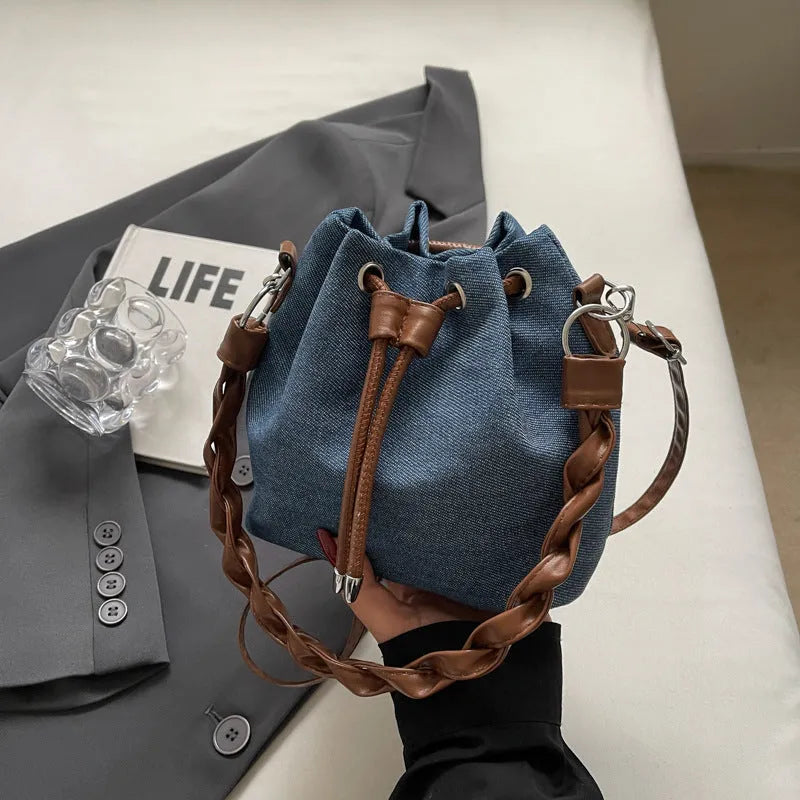 Blue cross body bucket messenger bag with synthetic leather lining and sandwich pocket organisation