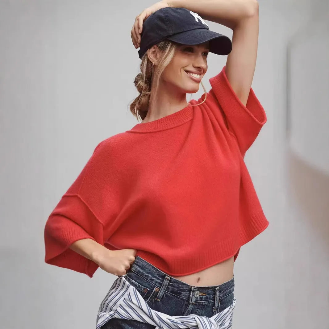 Red short sleeve viscose crop top with an exposed navel design on a model.