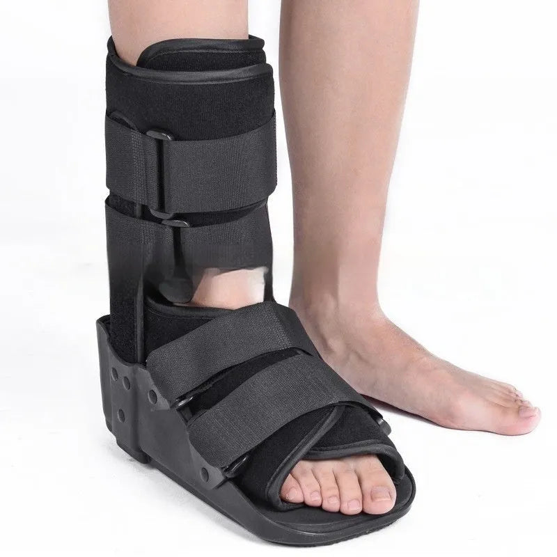 Achilles tendon rehabilitation walking boot in grey colour with adjustable strapping and rocker sole