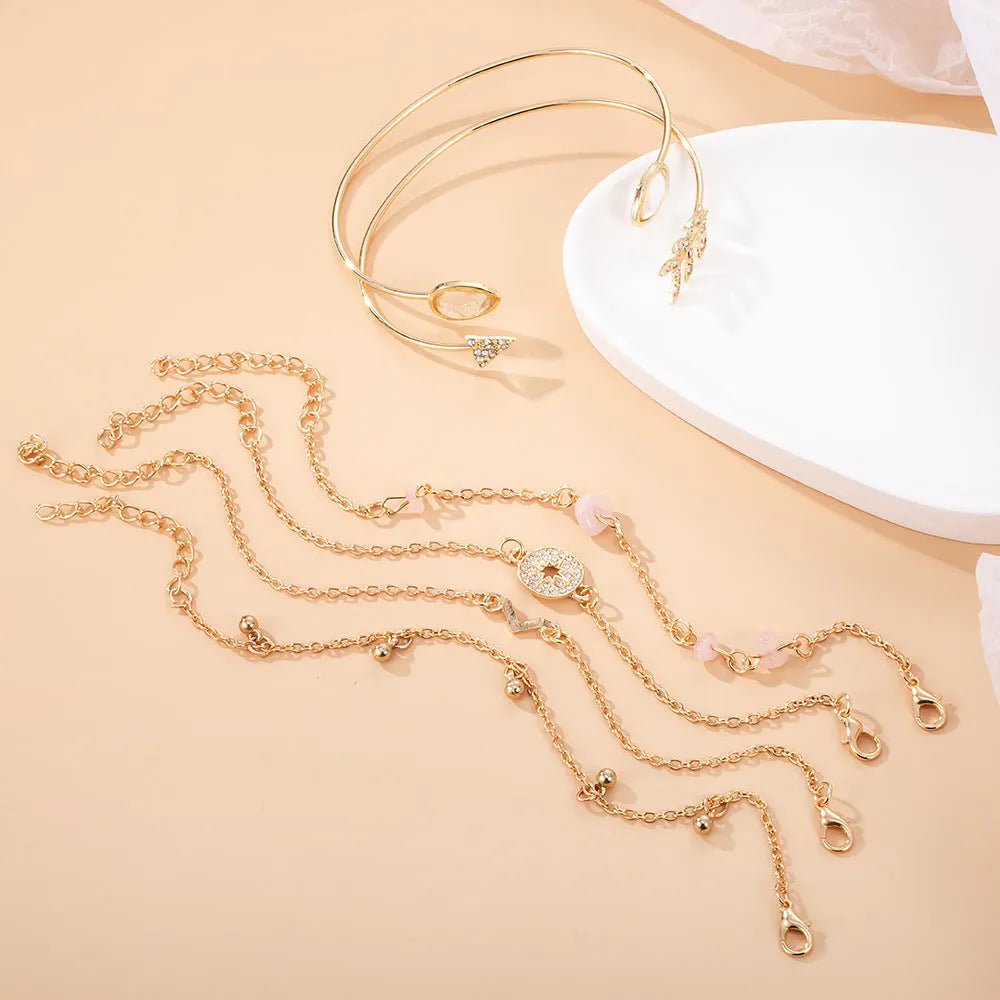 Golden spot drill arrow and water drop shaped bracelet set with six zinc alloy pieces