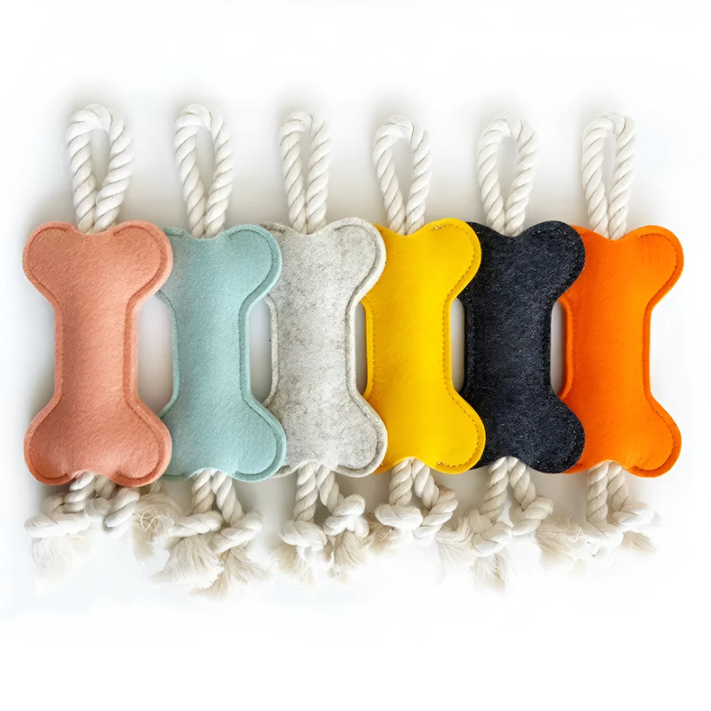 Bone-shaped dog chew toy with felt exterior showing rope knot texture inside, 16cm long in blue colour